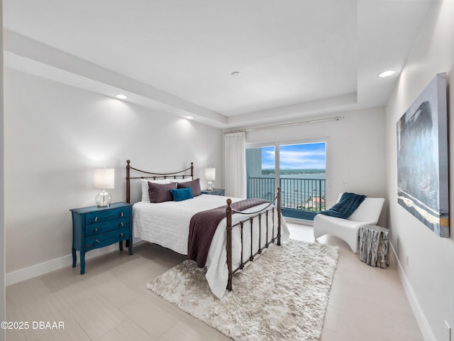 bedroom with recessed lighting, baseboards, access to exterior, and a raised ceiling