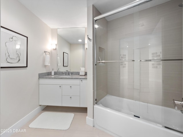 bathroom with baseboards, bath / shower combo with glass door, and vanity