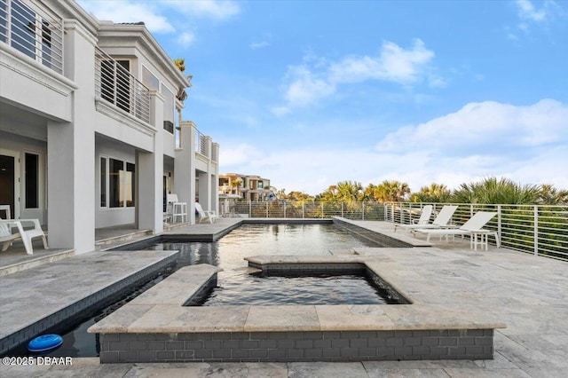 view of pool featuring a patio and an in ground hot tub