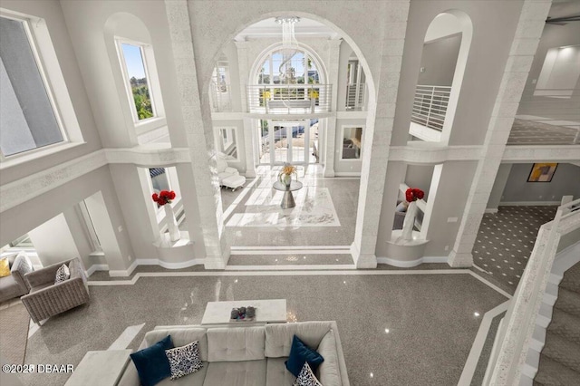 interior space featuring baseboards and a chandelier