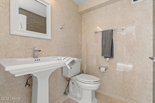 bathroom with tile patterned floors and toilet