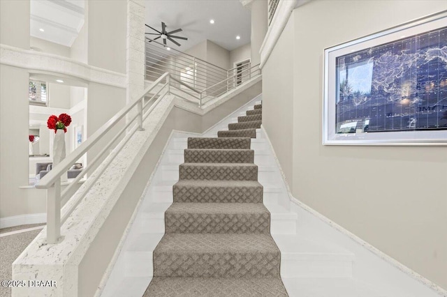 stairway with recessed lighting, baseboards, and a ceiling fan