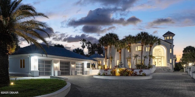 exterior space with an attached garage and decorative driveway