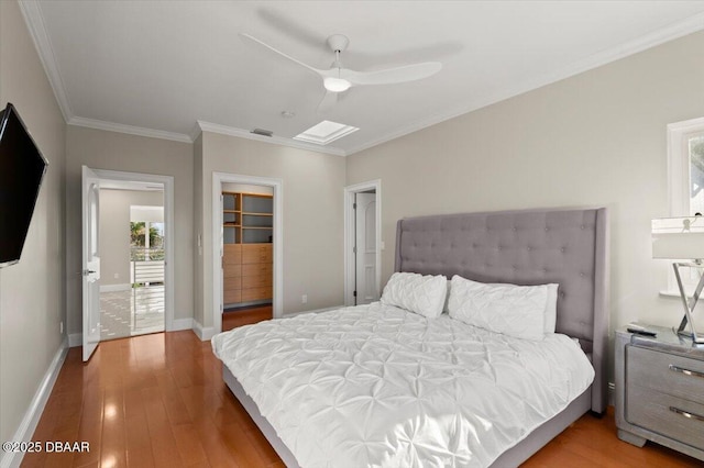 bedroom featuring wood finished floors, visible vents, baseboards, ceiling fan, and ornamental molding