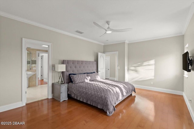 bedroom with visible vents, crown molding, baseboards, and wood finished floors