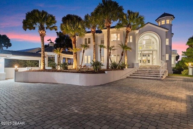 mediterranean / spanish home with french doors and stucco siding