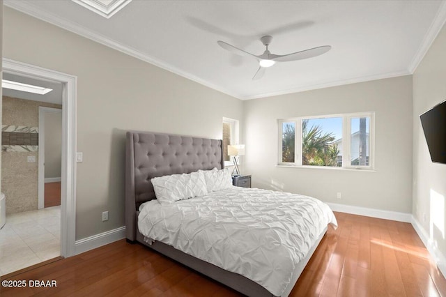 bedroom featuring light wood-style flooring, crown molding, and baseboards