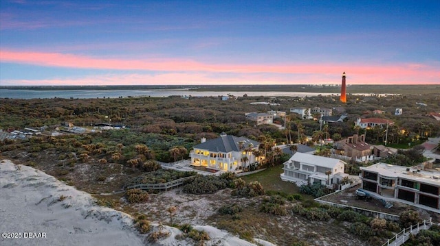 aerial view at dusk with a water view