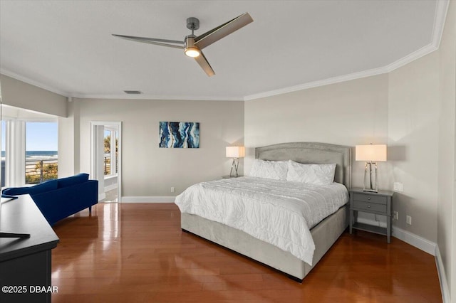 bedroom featuring visible vents, wood finished floors, baseboards, and ornamental molding