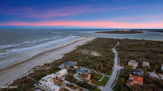 drone / aerial view featuring a water view and a beach view