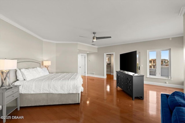 bedroom with visible vents, ornamental molding, baseboards, and wood finished floors