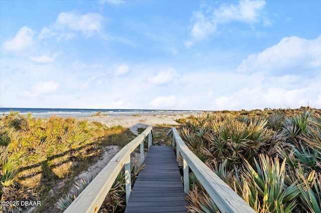 surrounding community featuring a beach view and a water view