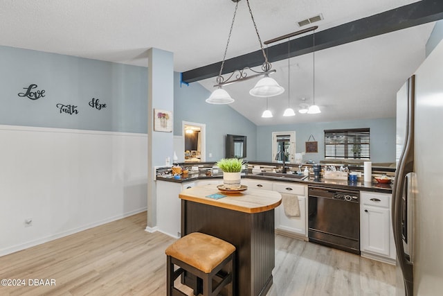 10 Pine Brook Dr, Palm Coast, FL 32164 - kitchen with dishwasher, a kitchen breakfast bar, a kitchen island, white cabinetry, and stainless steel fridge