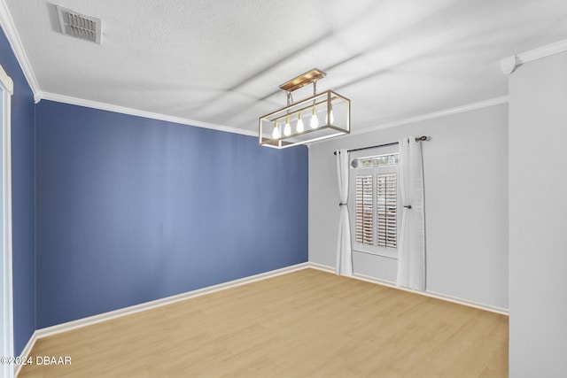 10 Pine Brook Dr, Palm Coast, FL 32164 - spare room featuring ornamental molding, wood-type flooring, and a textured ceiling