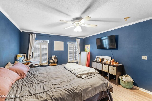 10 Pine Brook Dr, Palm Coast, FL 32164 - bedroom featuring ornamental molding, wood-type flooring, ceiling fan, and a textured ceiling