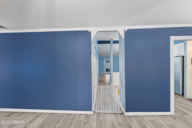 10 Pine Brook Dr, Palm Coast, FL 32164 - unfurnished room featuring light wood-type flooring, a textured ceiling, and crown molding