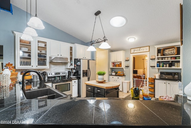 10 Pine Brook Dr, Palm Coast, FL 32164 - kitchen with vaulted ceiling, white cabinets, sink, appliances with stainless steel finishes, and decorative light fixtures