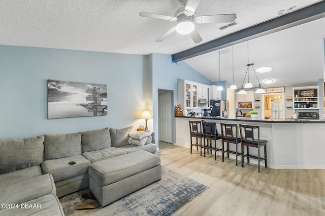 10 Pine Brook Dr, Palm Coast, FL 32164 - living room with lofted ceiling with beams, light wood-type flooring, a textured ceiling, and ceiling fan