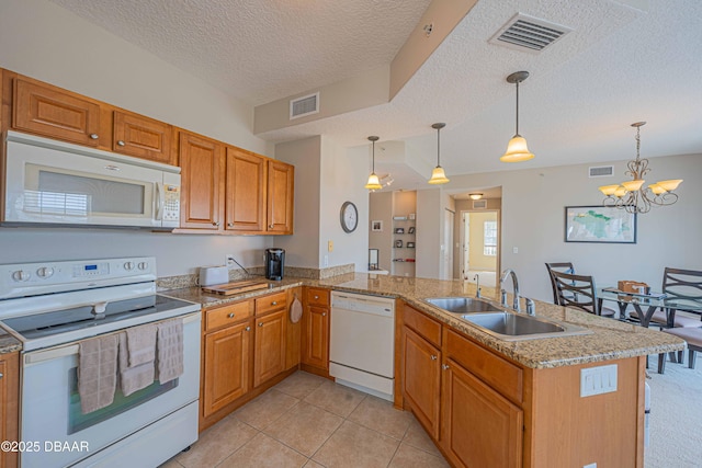 3756 S Atlantic Ave Unit 101, Daytona Beach, FL 32118 - kitchen featuring visible vents, white appliances, a peninsula, and a sink