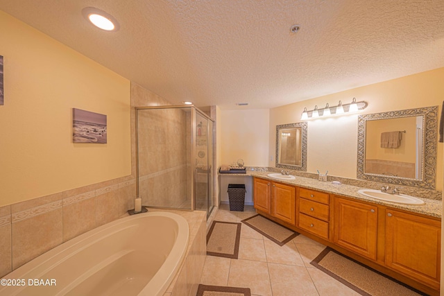 3756 S Atlantic Ave Unit 101, Daytona Beach, FL 32118 - bathroom with tile patterned floors, a stall shower, a garden tub, and a sink