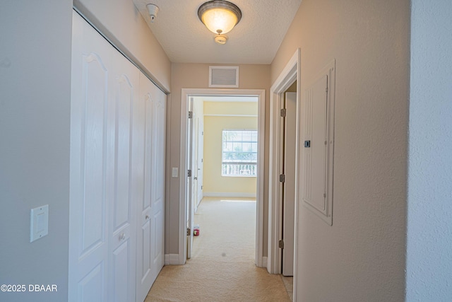 3756 S Atlantic Ave Unit 101, Daytona Beach, FL 32118 - corridor with light colored carpet, visible vents, a textured ceiling, and baseboards