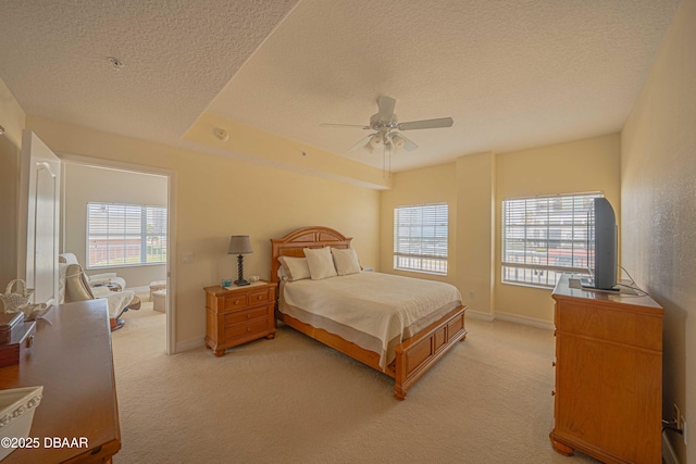 3756 S Atlantic Ave Unit 101, Daytona Beach, FL 32118 - bedroom with a textured ceiling, ceiling fan, baseboards, and light carpet