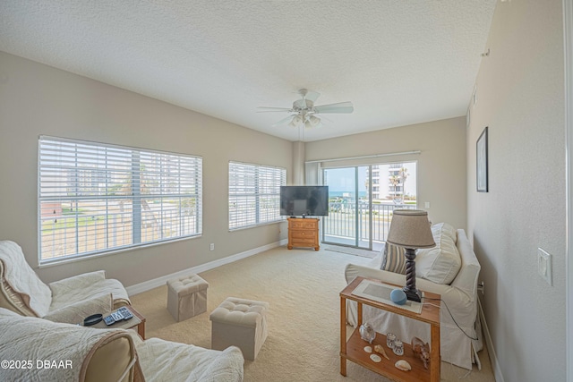 3756 S Atlantic Ave Unit 101, Daytona Beach, FL 32118 - living area with a ceiling fan, a textured ceiling, light carpet, and baseboards