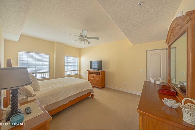 3756 S Atlantic Ave Unit 101, Daytona Beach, FL 32118 - bedroom featuring a textured ceiling, ceiling fan, light colored carpet, and baseboards