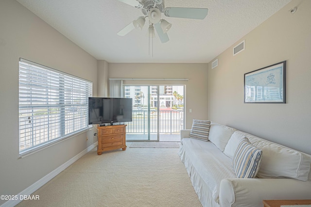 3756 S Atlantic Ave Unit 101, Daytona Beach, FL 32118 - living area featuring baseboards, visible vents, a ceiling fan, and light colored carpet