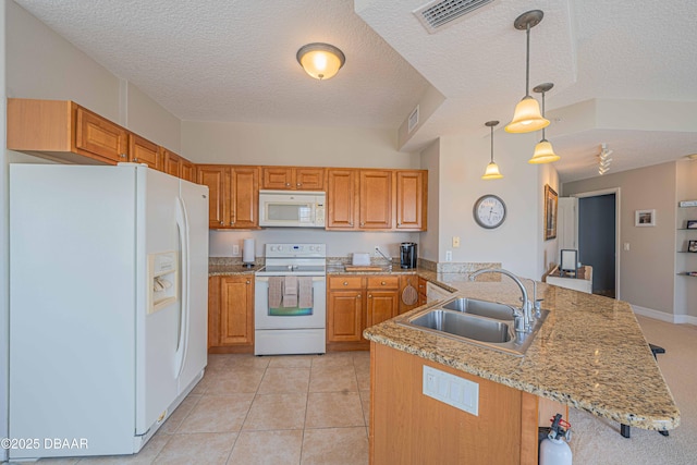 3756 S Atlantic Ave Unit 101, Daytona Beach, FL 32118 - kitchen with white appliances, a textured ceiling, a sink, visible vents, and a peninsula