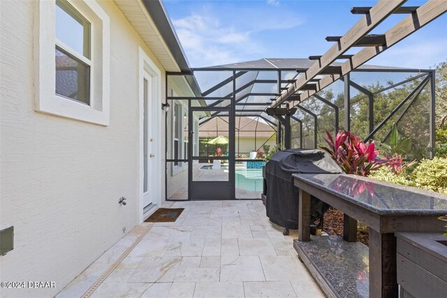 view of patio / terrace with a lanai and grilling area