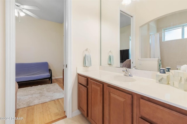 bathroom with vanity, hardwood / wood-style flooring, and ceiling fan