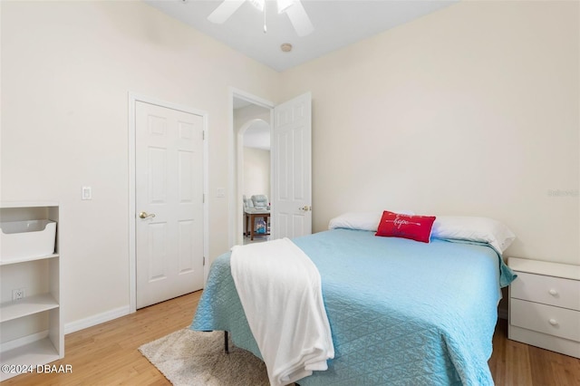 bedroom with light hardwood / wood-style floors and ceiling fan