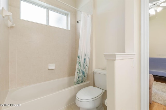 bathroom featuring shower / tub combo with curtain, toilet, and wood-type flooring