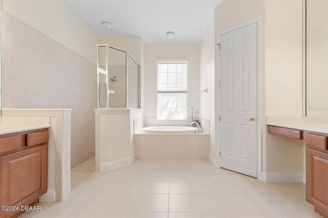 bathroom featuring shower with separate bathtub, vanity, and tile patterned flooring