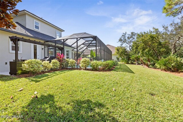 view of yard featuring glass enclosure