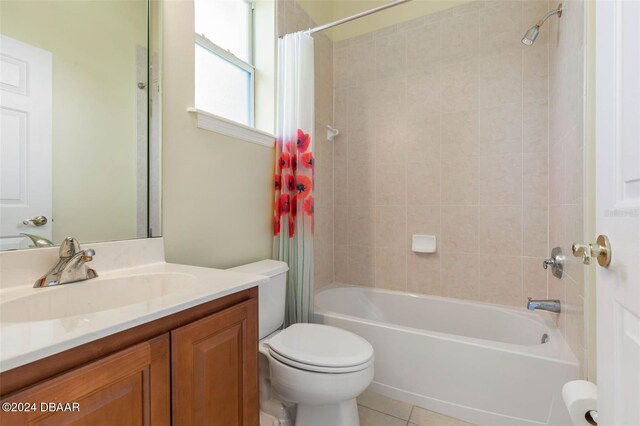 full bathroom with shower / bath combo, toilet, vanity, and tile patterned floors