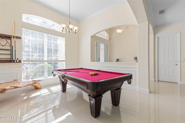 playroom with ornamental molding, plenty of natural light, light tile patterned floors, and a notable chandelier