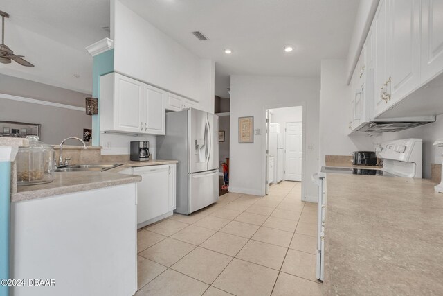 kitchen featuring vaulted ceiling, white cabinets, stainless steel refrigerator with ice dispenser, dishwasher, and sink