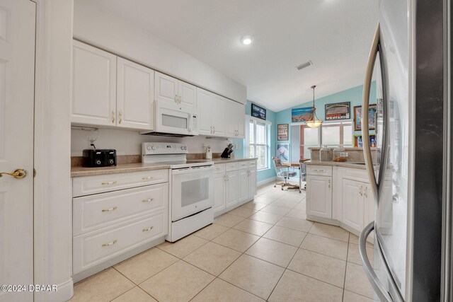 kitchen with white appliances, white cabinetry, pendant lighting, and vaulted ceiling