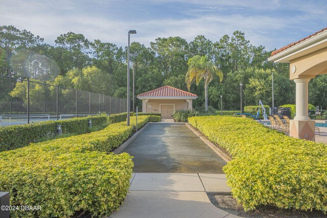 view of property's community with tennis court