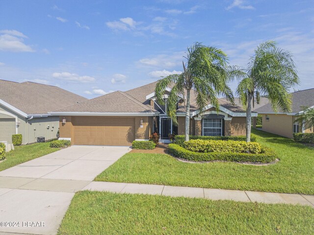 ranch-style house with a garage and a front yard