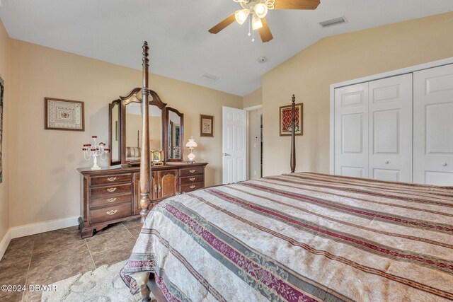 bedroom with light tile patterned floors, lofted ceiling, ceiling fan, and a closet