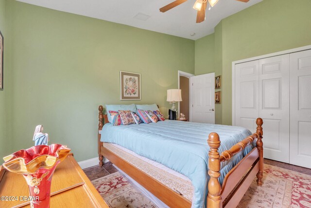 bedroom with ceiling fan, tile patterned floors, and a closet