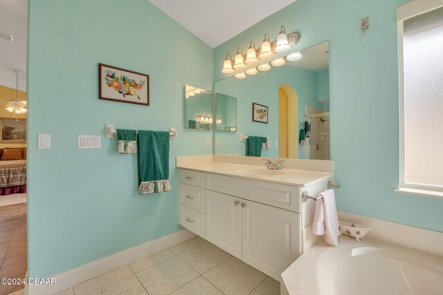 bathroom featuring vanity, plus walk in shower, tile patterned floors, and ceiling fan