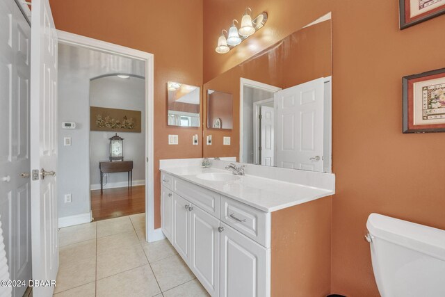 bathroom with vanity, tile patterned flooring, and toilet