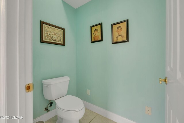 bathroom with toilet and tile patterned flooring