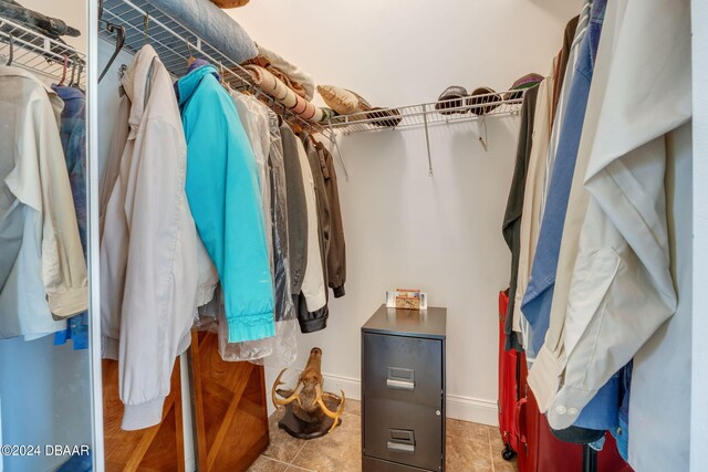 walk in closet with tile patterned floors