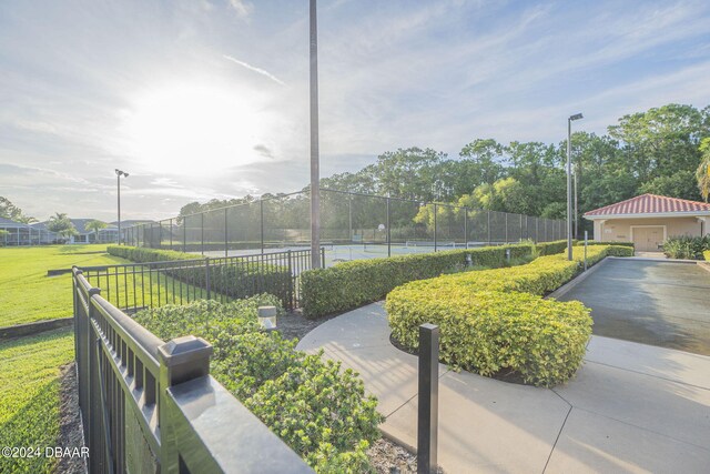 surrounding community featuring tennis court