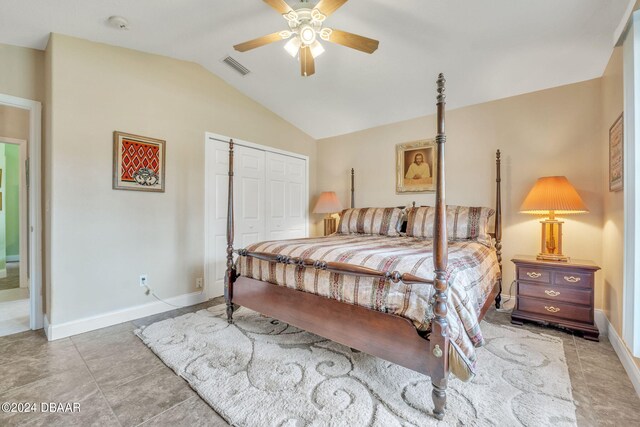 bedroom with ceiling fan, tile patterned floors, a closet, and vaulted ceiling